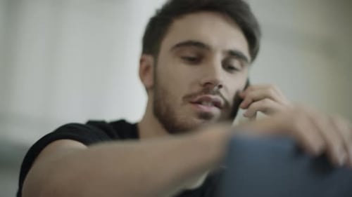 Young Man Talking on Phone Indoors