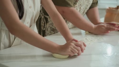 Anonymous People Rolling out Dough for Pastries