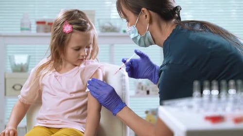 Doctor Giving Vaccination to a Young Girl