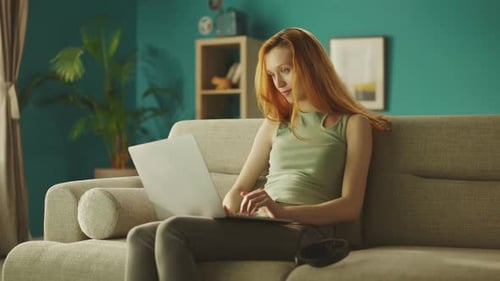 Young Woman Working on Laptop at Home