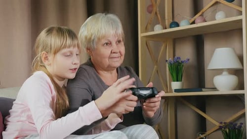 Grandmother and Granddaughter Playing Video Games Together