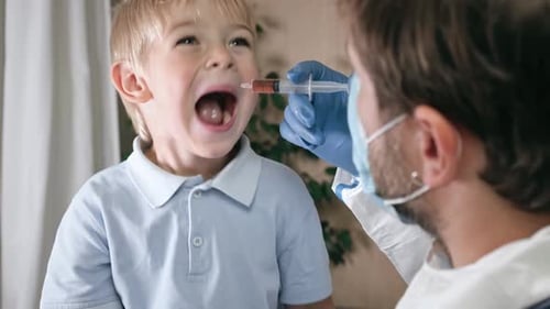 Doctor Giving Medicine to Child Patient at Home