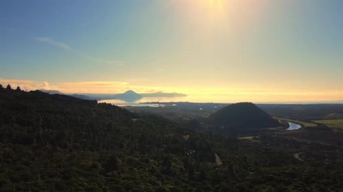 High Drone shot dusk dense bushland trees large river and large hill