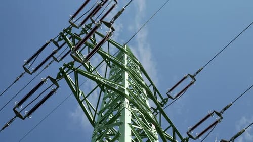 Green Utility Tower Against Blue Sky