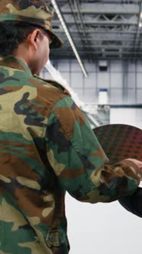 Vertical Video Soldier and Microchip Factory Engineer Discuss About Silicon Wafer