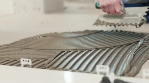 Applying Adhesive with Trowel for Tile Install