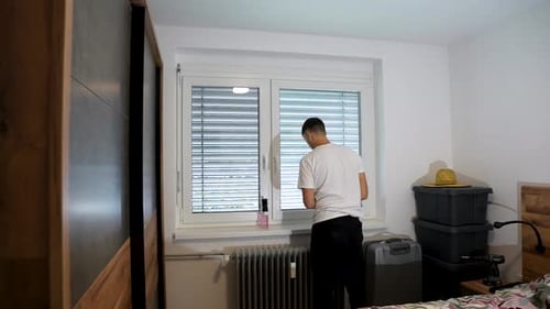 Time lapse of a man cleaning bedroom new window