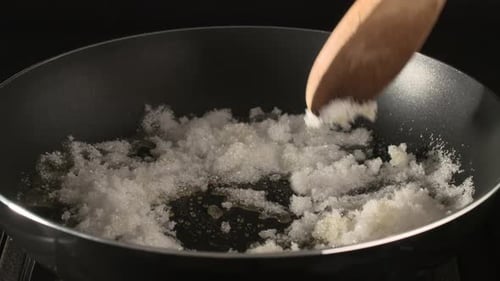 melted sugar is boiling in a pot on Gas stoves, making of caramel for cake and desserts - high speed