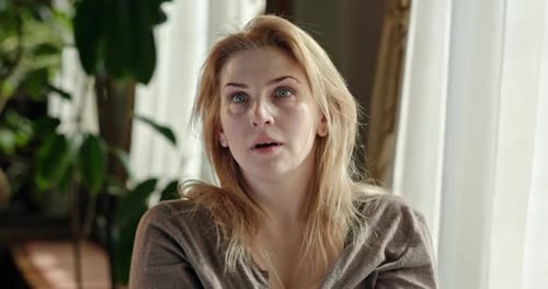 Woman Reacts with Surprise Indoors During Daytime