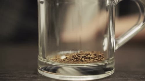 Instant Coffee Pieces Falling in Glass Cup Cropped Close Up Slow Motion