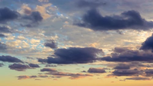 Dramatic Clouds Sweeping Across Sky During Golden Hour