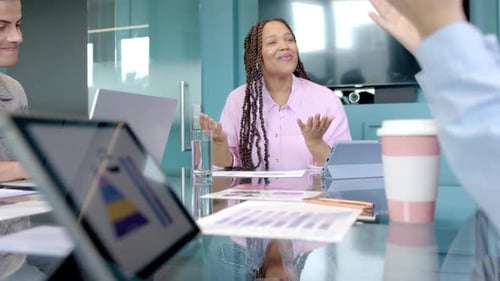 Smiling woman in meeting, discussing business strategy with colleagues in office
