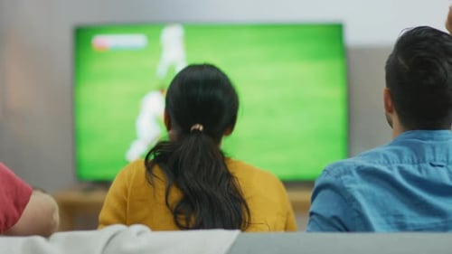 People watch an exciting sports game on TV