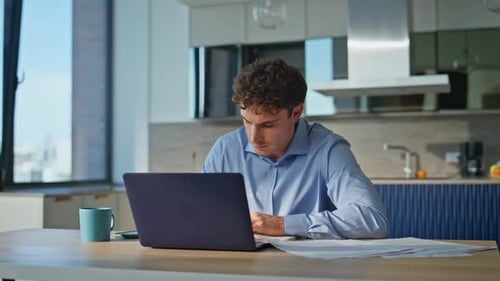 Young Adult Working At Home On Laptop
