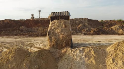 Mining truck transporting sand at sand quarry. Aerial. Drone. 4K.