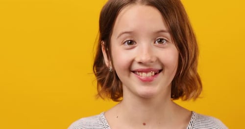 Portrait Happy Girl Teenage in Yellow Studio Background