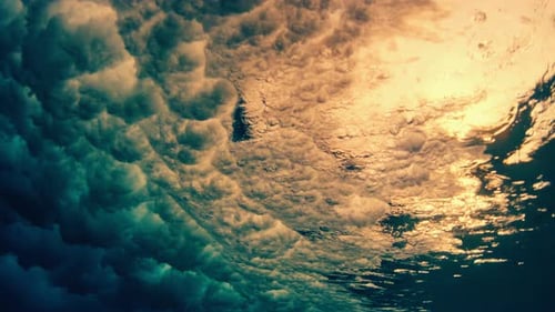 Ocean wave breaks on the shore, underwater view of the wave