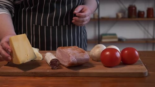Cheese, Cured Meats, and Vegetables on Cutting Board