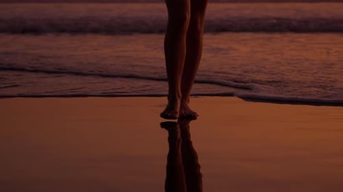 Legs Walking on Beach at Sunset
