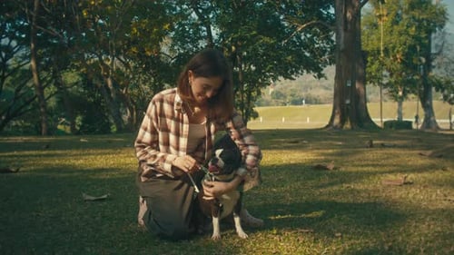 Woman and Dog Bonding in a Park