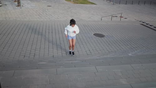 Woman Running Up Urban Concrete Steps