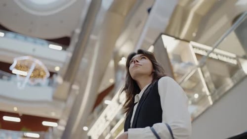 Young Woman Contemplating in a Busy Shopping Mall