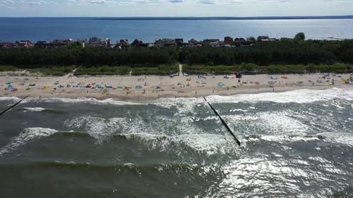 Baltic Sea coast beach Hel aerial drone top view 4K UHD video. People on the beach. Aerial View