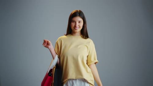 Woman Smiling and Waving with Shopping Bags