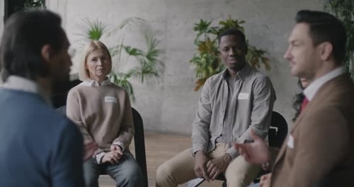 Multiethnic Group of People Sharing Problems and Ideas During Therapy Session in Rehab Clinic
