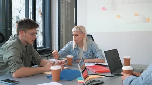Diverse group of young people working on new project together in office.