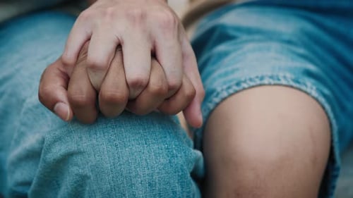 Two Adults Holding Hands in Close Up