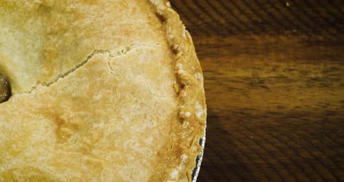 Golden Brown Pie on Wooden Surface
