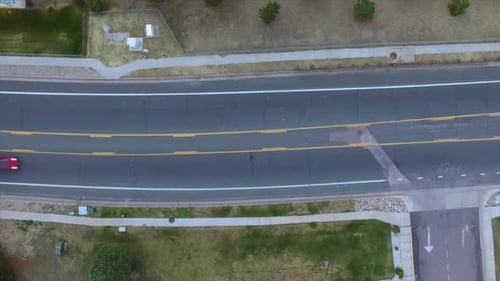 A Drone Aerial of Cars driving down a Road.