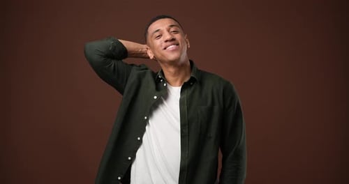 Young African American Man Satisfied Happy Guy Standing Over Brown Studio Background