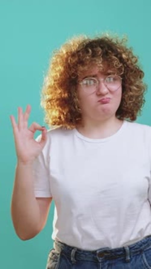 Curly Haired Woman Makes OK Hand Gesture