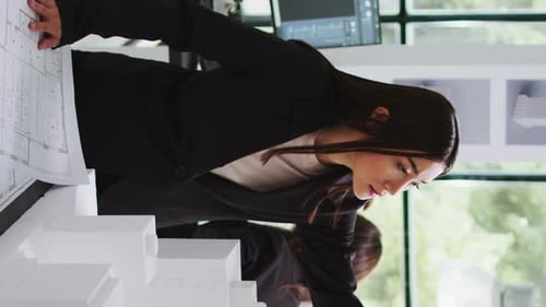 Vertical Video Architecture Office Employee Looking at Building Model