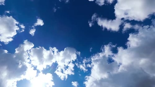 Blue Sky with White Clouds. Puffy Fluffy White Clouds Moving Fast. Cumulus Cloudscape Timelapse
