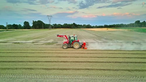 Tractor Working in a Field Surrounded by Farmlands - Aerial View 4K