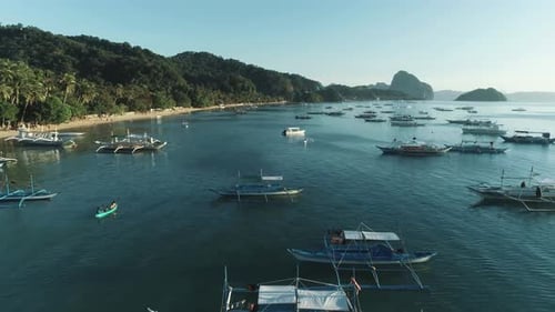 Aerial Drone View of Boats Anchored in the Bay with Clear and Turquoise Water on the Sunset Boat and