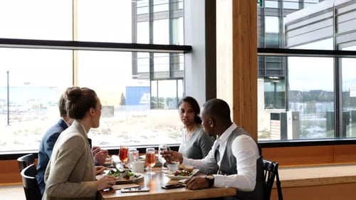 Multiethnic business team enjoys working lunch and collaboration in restaurant