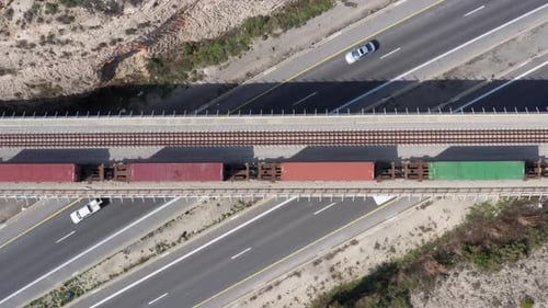 Tren de carga cargado con contenedores de transporte que pasan