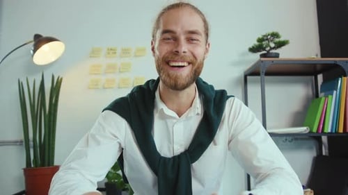 Smiling Man at Desk in Modern Office