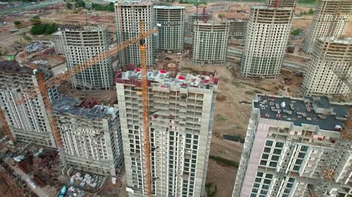 Aerial view. Construction site. A lot of buildings and cranes.