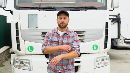 Portrait of Confident Truck Driver on Parking Lot Looking at Camera Copy Space