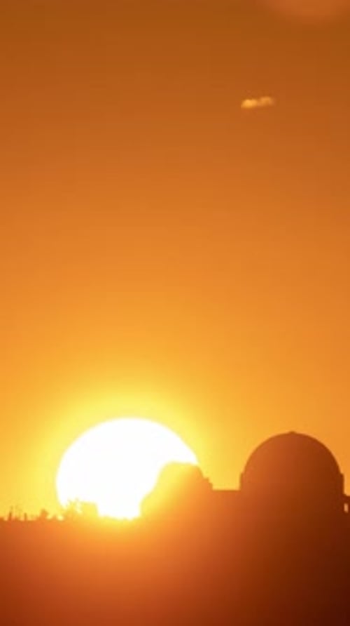 Vertical time lapse of the sun rising from behind the Griffith Observatory in Los Angeles