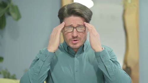 Man Rubbing Temples Feeling Headache Pain