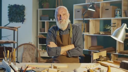 Senior Craftsman Posing Proudly in His Woodworking Shop