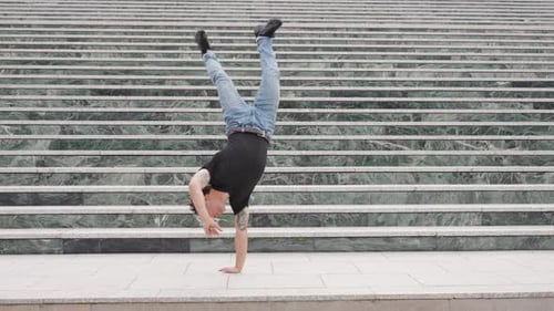 Man Dancing and Doing Acrobatics on Sidewalk