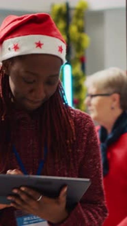 Woman in Santa Hat Using Tablet at Office