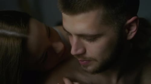 Loving Couple Embracing in Dark, Intimate Setting